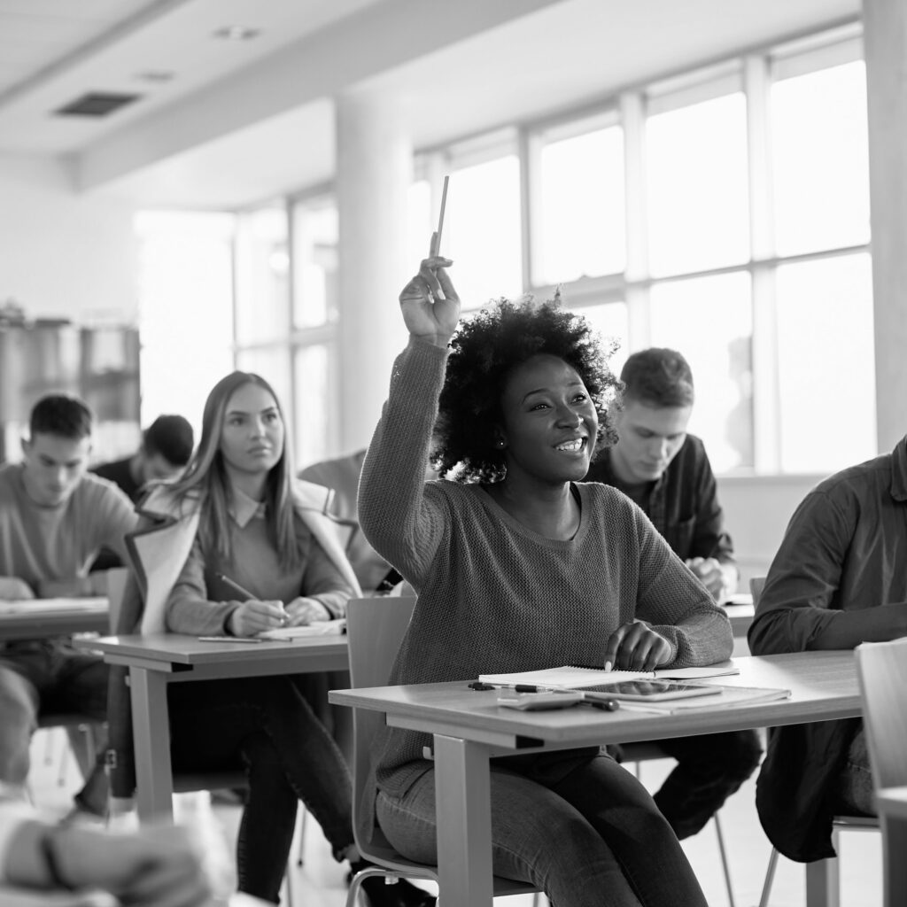 Student raising hand in classroom